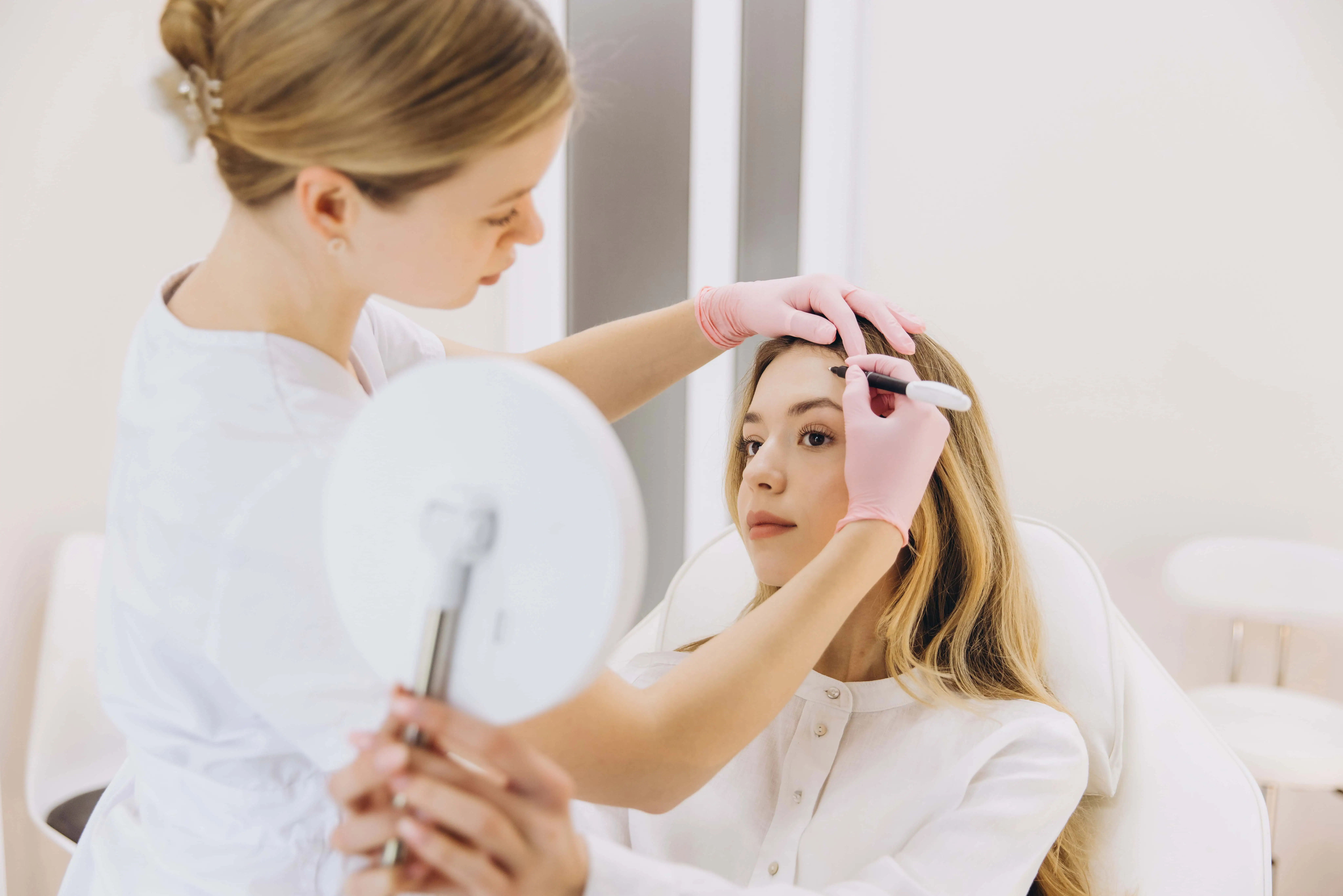Medical aesthetician administering injectable treatment for cosmetic enhancement